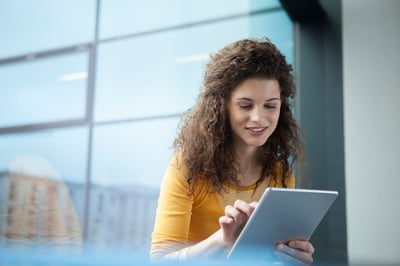smiling-young-woman-using-digital-tablet-at-the-w-2024-09-22-20-11-36-utc