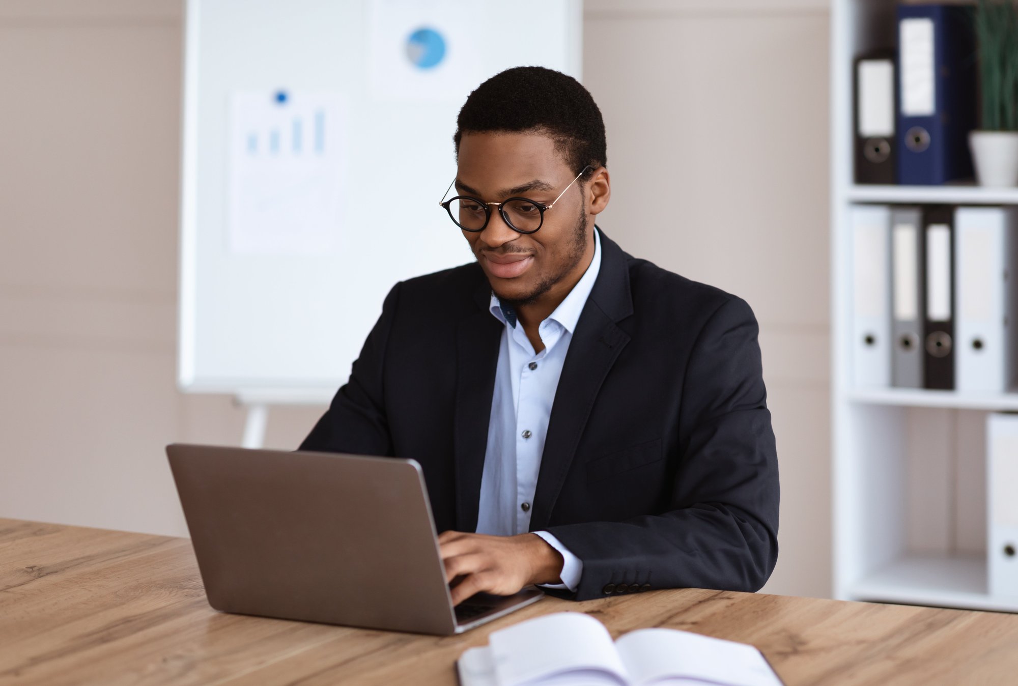 young-black-entrepreneur-working-with-laptop-offi-2023-11-27-05-36-35-utc
